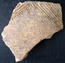 [photo] Pottery sherd decorated with linear patterns.