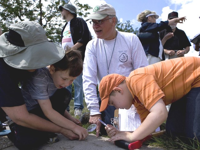 scientist showing students fossils
