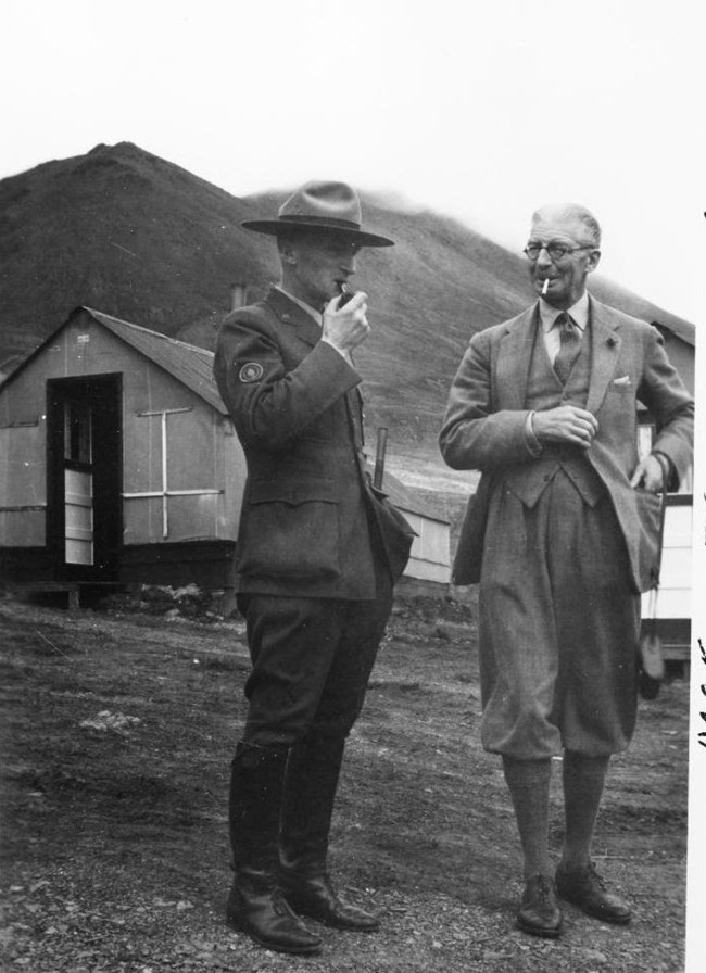 rumohr philips 4 a park ranger and another man standing near a small cabin