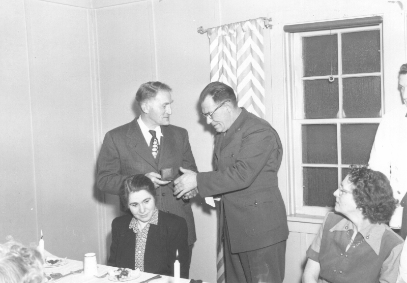 two men and two women at a dining room table