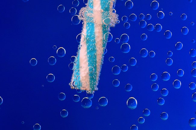 A single plastic straw in liquid