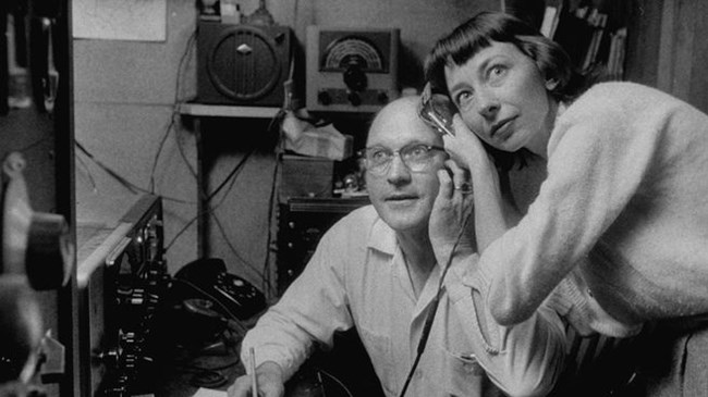 Listening to Sputnik A man and woman share a radio headset