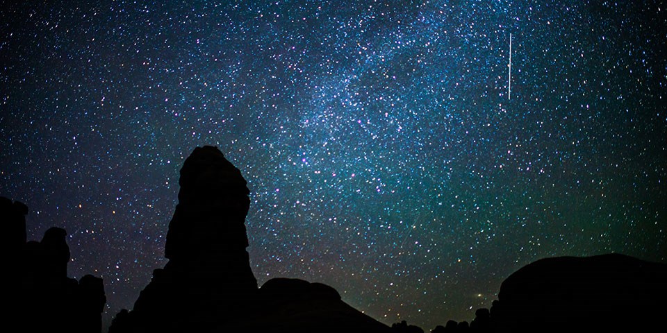 starry night sky over rock formation