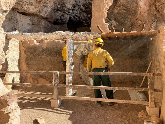 Cliff dwelling roof beam wrapped by crew