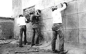 tuma1fig6 Men work on wall.