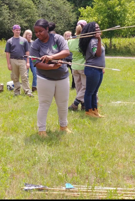 UAC participants learning how to use an atlatl