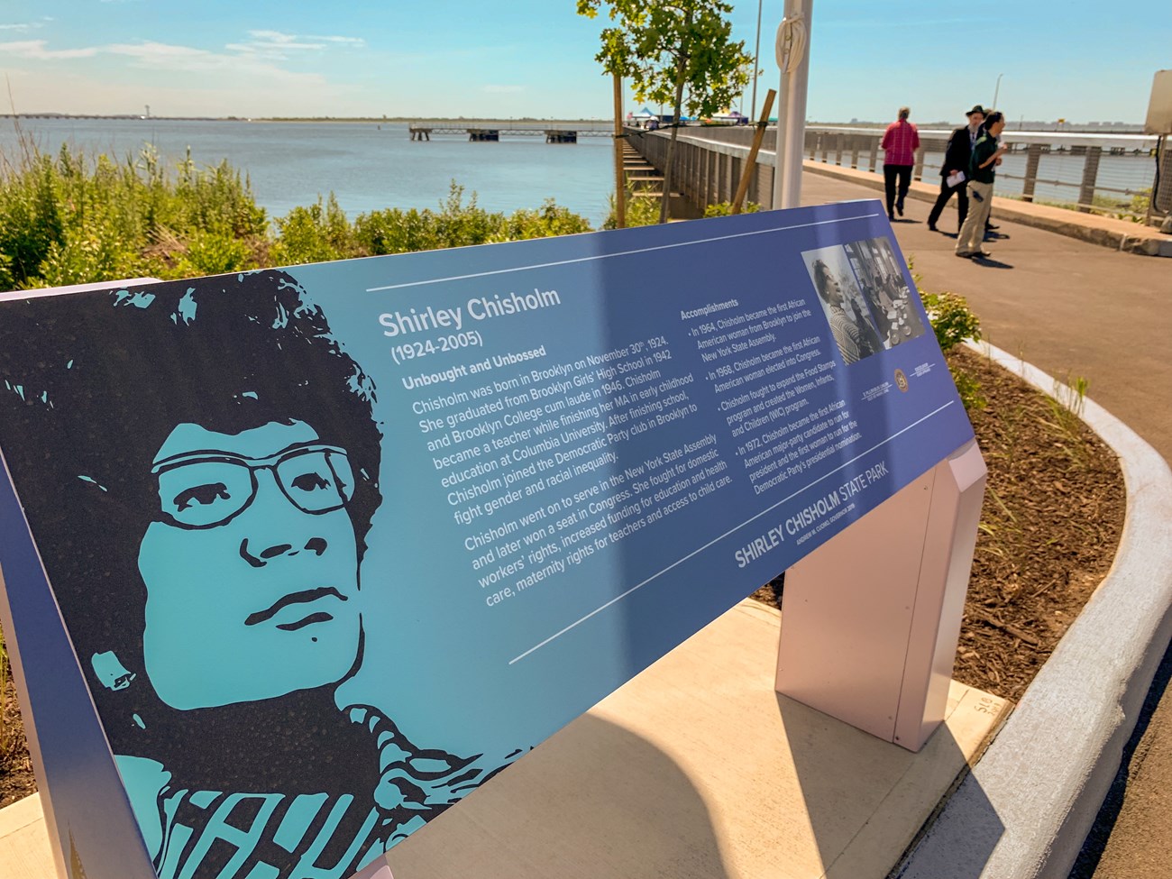 A sign at the park tells the story of Shirley Chisholm