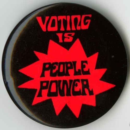 Red and black button with"Voting is People Power," written on it. National Museum of American History, Smithsonian Institution. Red and black button with"Voting is People Power," written on it. National Museum of American History, Smithsonian Institution.