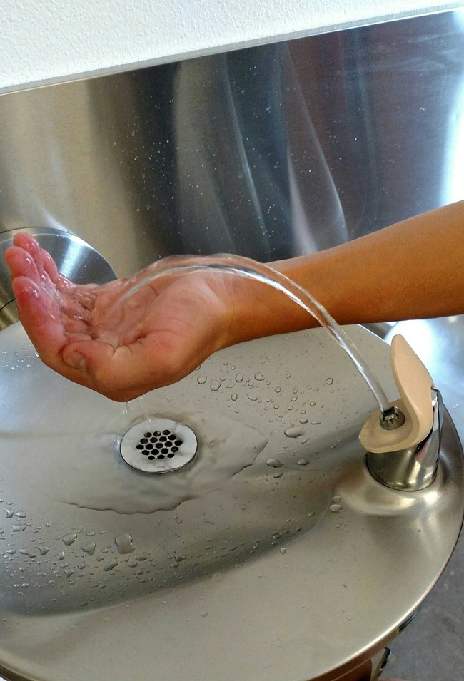 hand in drinking fountain