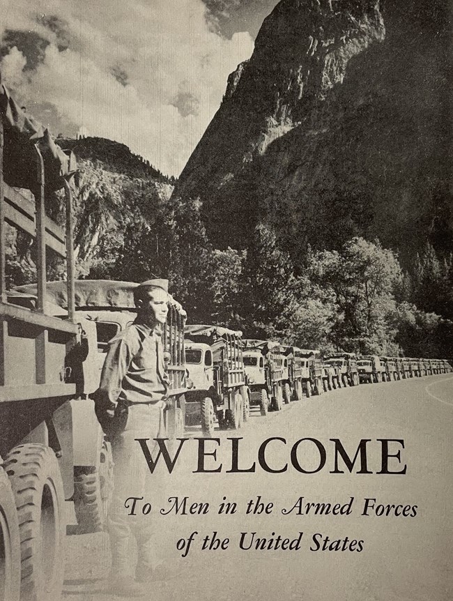 Cover of pamphlet with military vehicles lined up along a road with mountains behind. "Welcome to the Men of the Armed Forces of the United States"