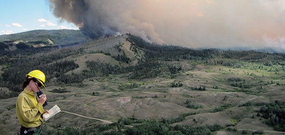 Teton Interagency Fire Effects crew member calls in via the radio. Teton Interagency Fire Effects crew member calls in via the radio.