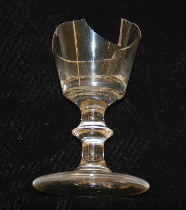 Wine glass Photo of wine glass with wide base and broken rim, small size overall.