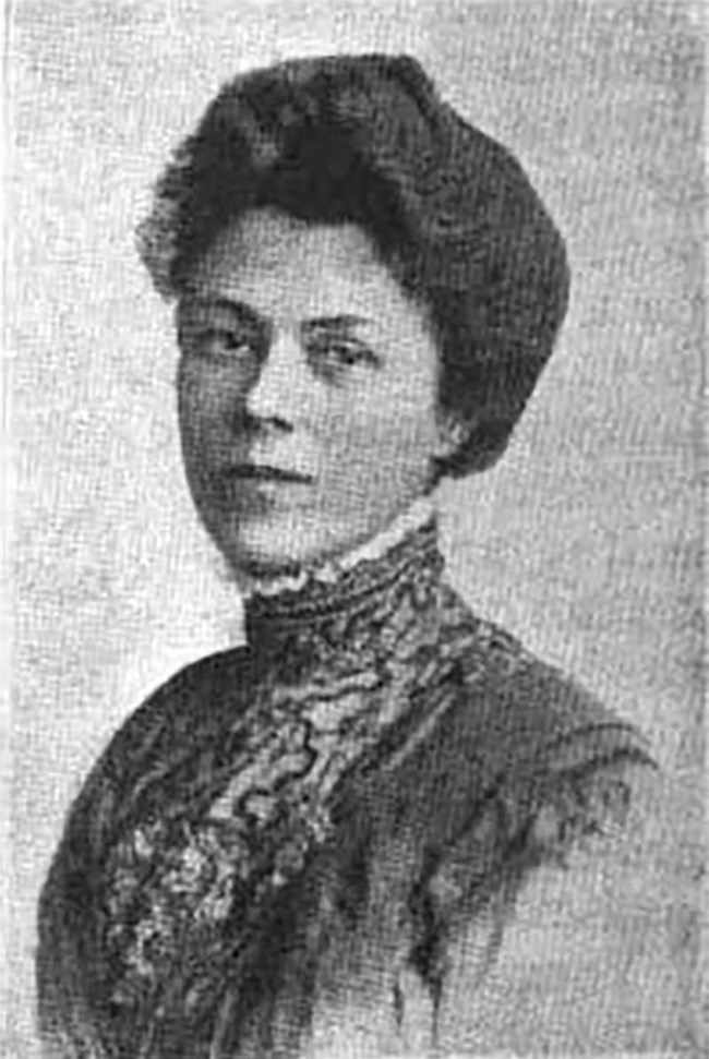 black and white portrait photo of a woman in a high necked dress