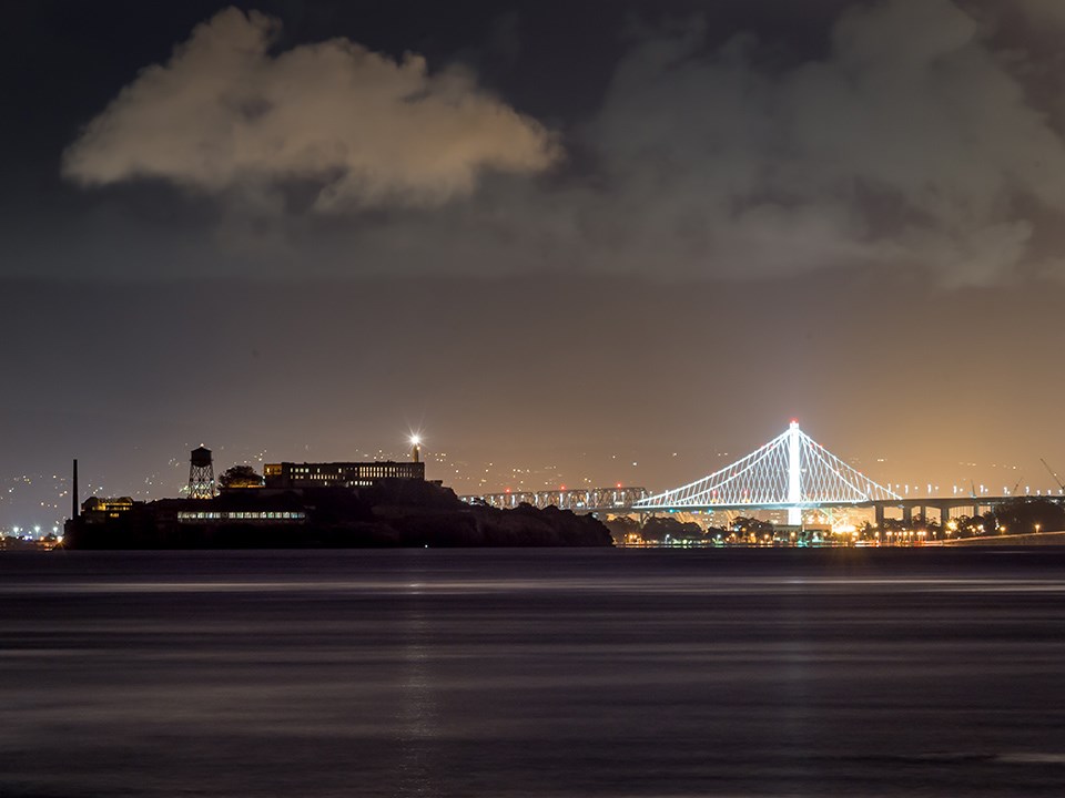 x4x3_Alison_Golden_gate_night_sky; Night skies over the San Francisco Bay, showing the illuminated bay bridge and Alcatraz.