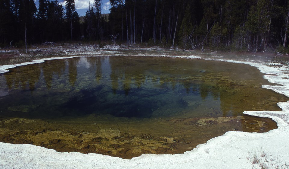 A thermal pool with drown edges and a dark center