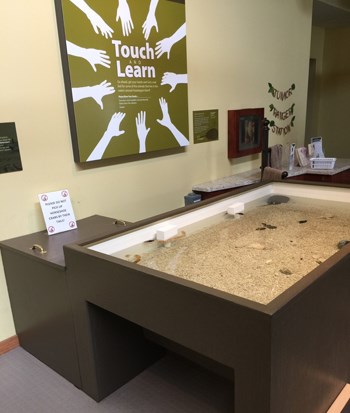 Touch tank in the Maryland visitor center. Touch/Learn sign in background