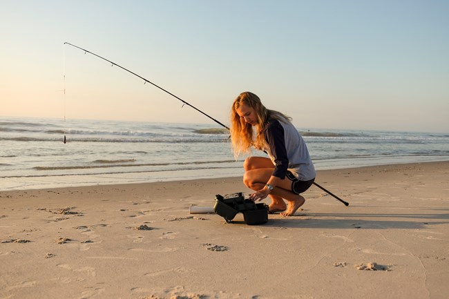 An angler selecting the proper equipment from their tackle box