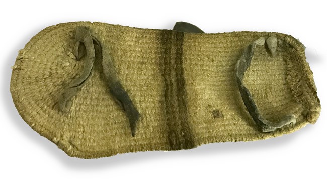 An ancient woven sandal for a child made from a yucca plant.