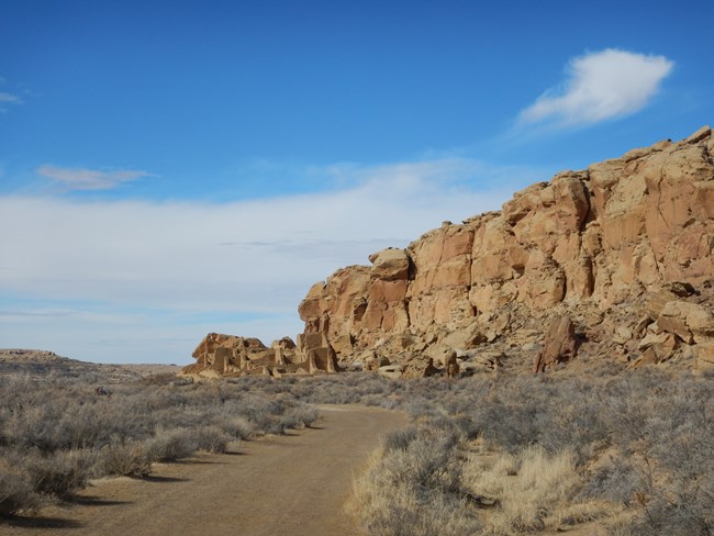 Sandstone cliffs at Chaco, with Kin Kletso visible in the foreground.