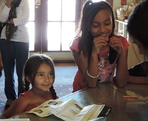 Junior Rangers talking about their activity sheets with a ranger