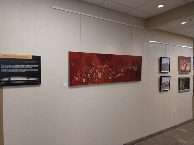 art gallery wall with several pieces of work on display