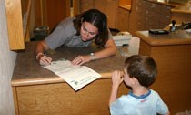 Ranger signs a child's Junior Ranger certificate Ranger signs a child's Junior Ranger certificate