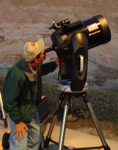 National Park Service volunteer views the park's night sky through an 11
