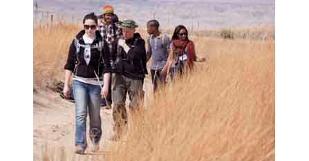 Group hikes a trail in the Badlands