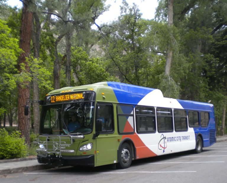 bus a multicolored bus sits at a curb