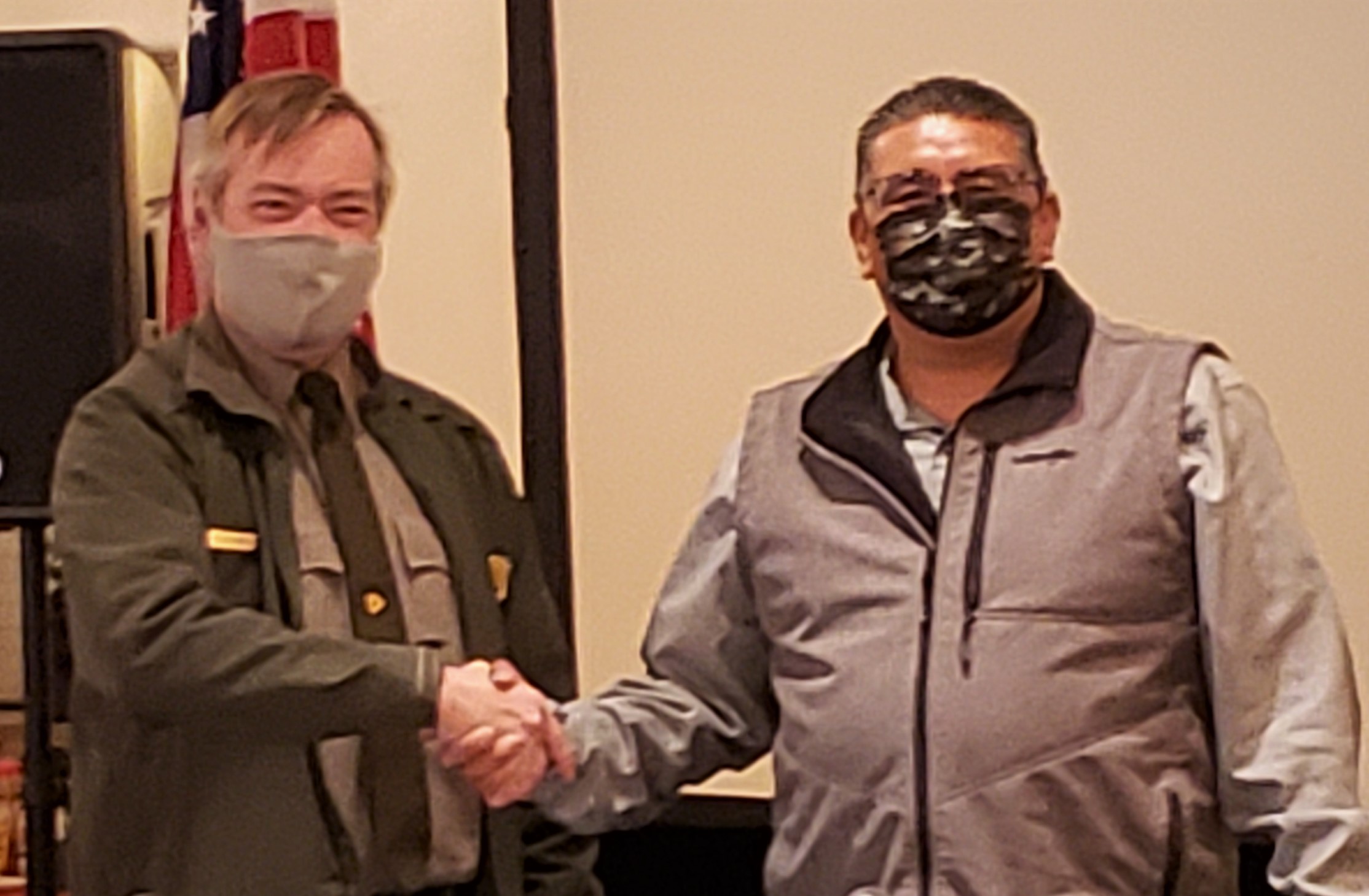 governor of Santa Clara and superintendent of Bandelier two men in masks shake hands