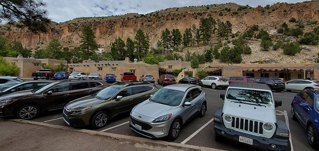 a variety of vehicles fill the parking lot