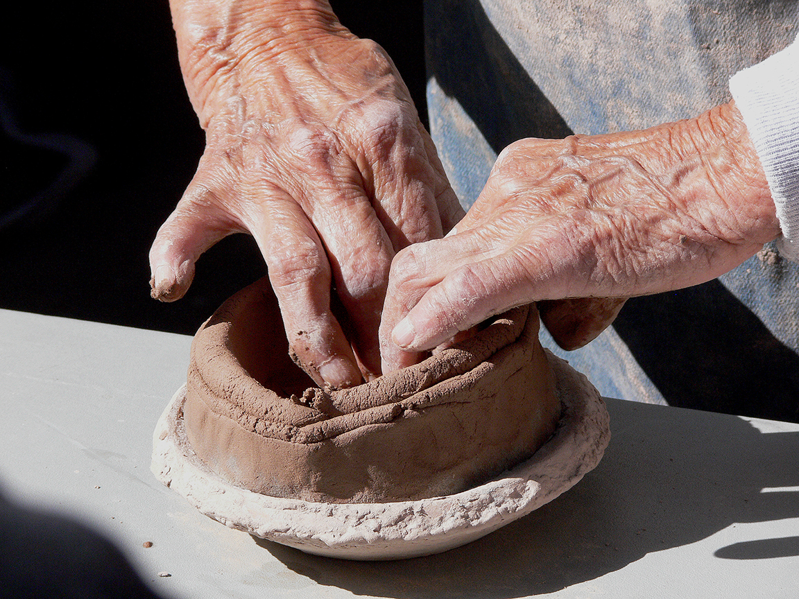 pottery making hands mold a pot from clay
