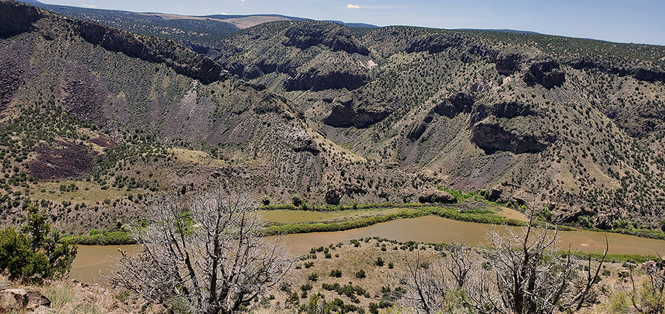 rio grande from burro trail web an Arial view of a sinuous river with the sun shining on it
