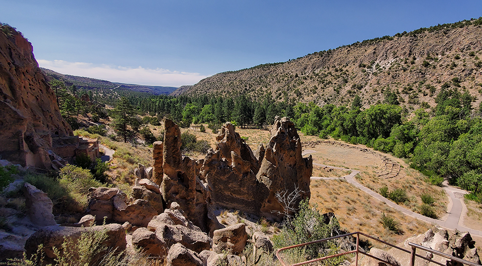 tyuonyi from near 2nd cavate web a view of a narrow canyon with a circular set of walls from an Ancestral Pueblo village