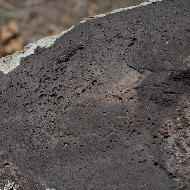 a black rock with holes