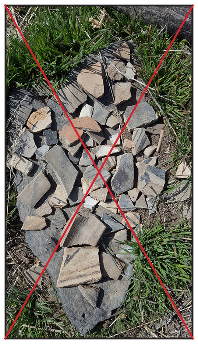 pottery shards piled on a rock with a big red x to say don't do this
