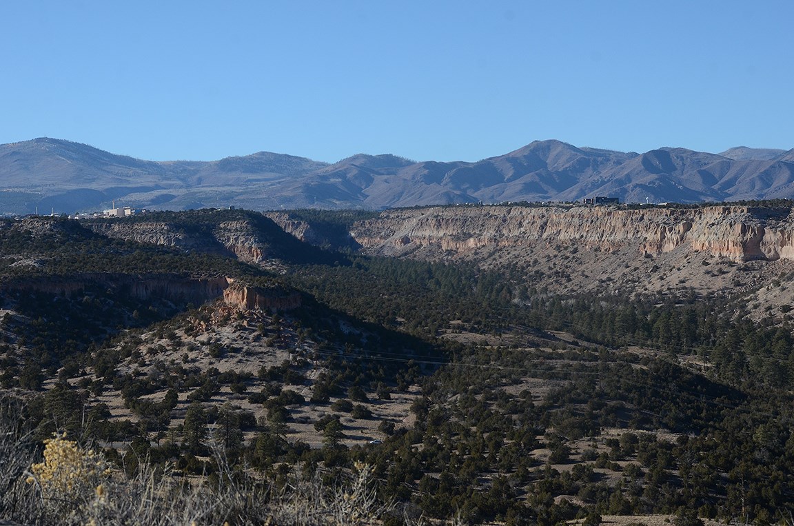the buildings of a town can be seen sitting on the flanks of a mountain