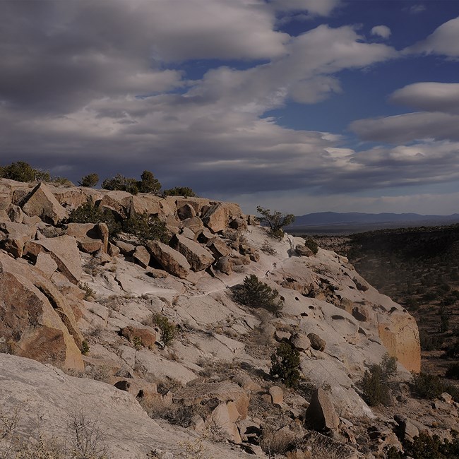 Orangey buff mesas stand out against a blue sky