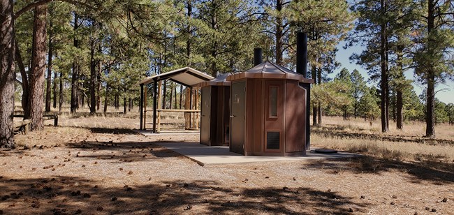 vault toilets and picnic shelters in campground