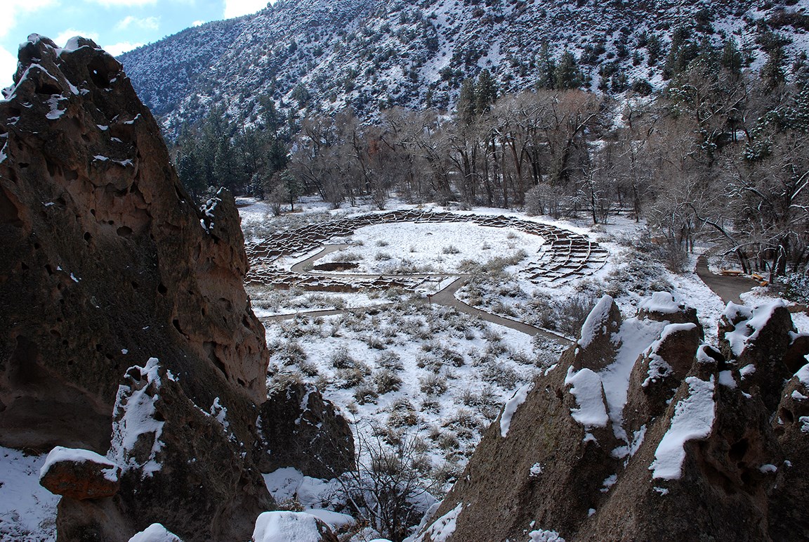 the remnants of a large stone structure in a canyon covered with snow