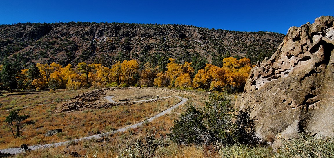 a view of a canyon with the remnants of a large stone structure