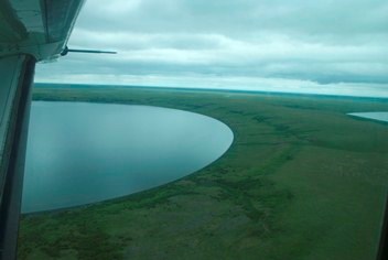 Aerial view of theround edge of the Northern Killeak Maar on the summer tundra