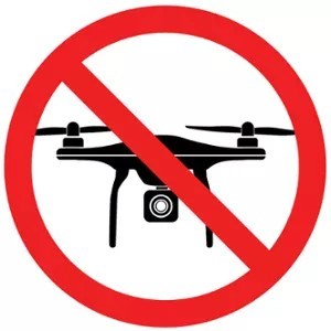 Red circle with a line through it over a graphic of a drone aircraft