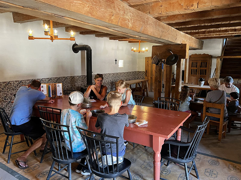 Families making bead necklaces at Bent's Old Fort