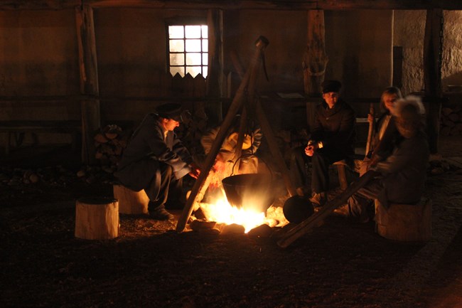 Living Historians around a fire at Bent's Old Fort