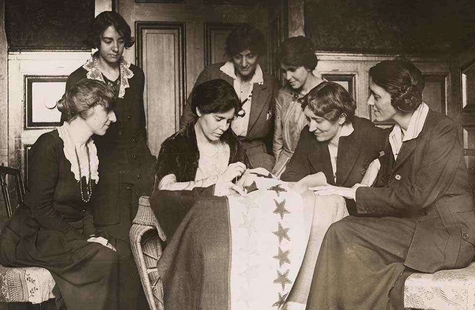 NWP activists watching Alice Paul Sew Star on Flag