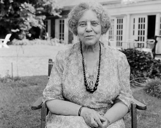 Alice Paul seated in the backyard of Belmont House