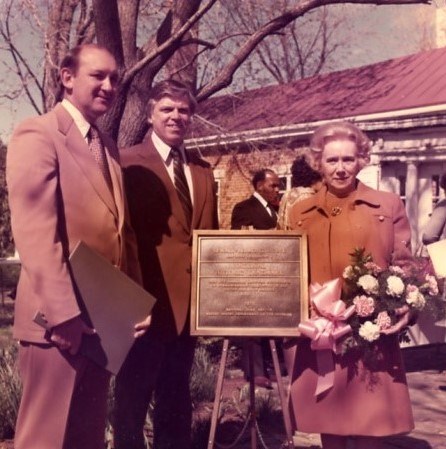 Landmark_1975_001_004_123_cropped Two men and a woman holding flowers pose around National Historic Landmark plaque in NWP garden