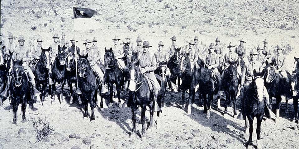 More than twenty mounted cavalrymen and their horses pose for a photo in 1916.