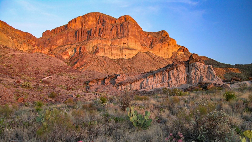 A mountain composed of volcanic ash flows and multi-colored layers of rock.